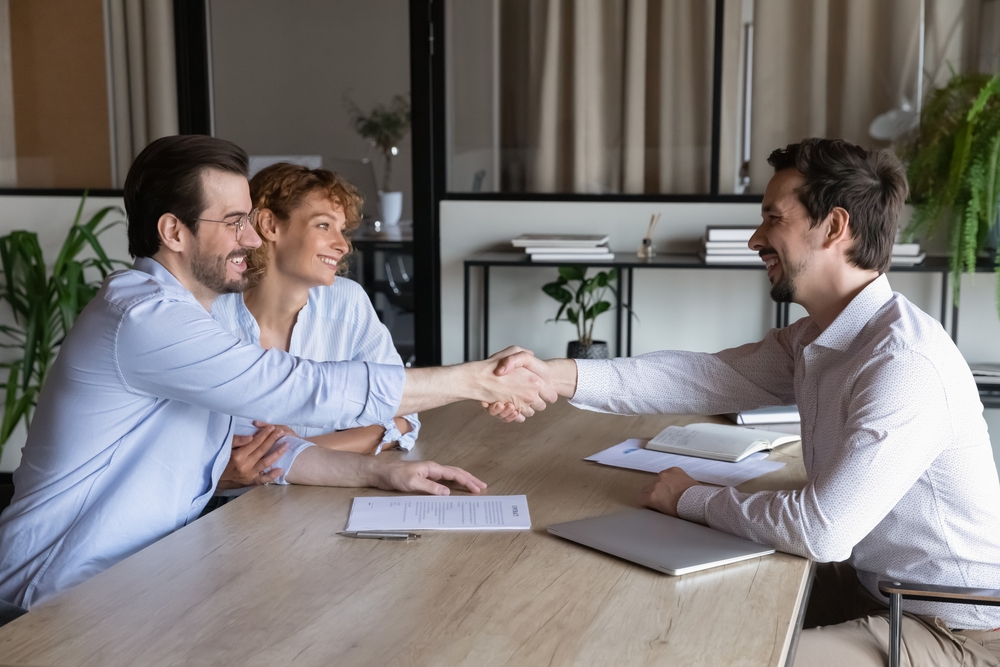 mortgage agent meeting with clients for a commercial mortgage deal
